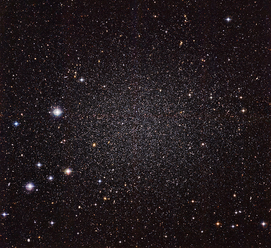 The Sculptor Dwarf Galaxy is a small galaxy close by the Milky Way. We can see other galaxy through it as its stars are quite sparse. Image Credit: ESO